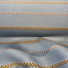 Sunbrella Linger Slate outdoor stripe fabric showing the soft blue woven ground and warm caramel check detail