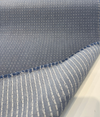 Close view of Sunbrella Lure Denim weave with small light gray dots on denim blue acrylic