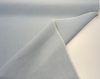 Close view of Sunbrella Play Sky weave showing the two-tone heathered light blue yarns