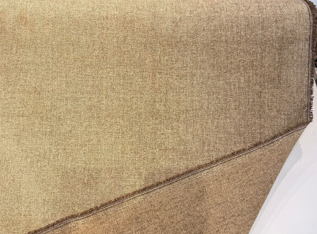 Bronze gold chenille fabric folded back to show the selvedge and reverse side