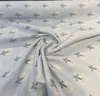 Sunbrella Mira Spring fabric folded back to show the striped reverse side of the jacquard