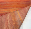 Sunbrella Express Sangria fabric on the roll showing sunset bands of red, orange, copper and gold