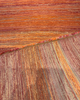 Sunbrella Express Sangria unrolled showing the full painterly ombré color variation