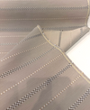 Sunbrella Linger Cashmere outdoor stripe fabric showing the soft sand woven ground and taupe check detail