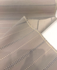 Sunbrella Linger Cashmere outdoor stripe fabric showing the soft sand woven ground and taupe check detail