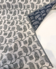 Sunbrella Lola Juniper sage green performance fabric on a textured ivory linen-look ground