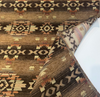 Caramel and tan striated chenille ground with terraced southwestern bands