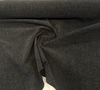 Densely woven solid black chenille upholstery fabric close up