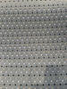 Close-up of the woven diamond trellis and dot pattern on dark teal