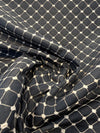 Knit-backed black and ivory honeycomb diamond upholstery fabric