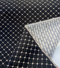 Close-up of the woven knots at each intersection of the ivory grid