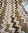 Opuzen Juno Natural flame stitch velvet, close-up of the brown and olive zigzag bands
