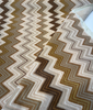 Opuzen Juno Natural flame stitch velvet, close-up of the brown and olive zigzag bands