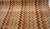 Opuzen Juno Canyon zigzag chevron velvet upholstery fabric in rust, burnt orange, brown and cream