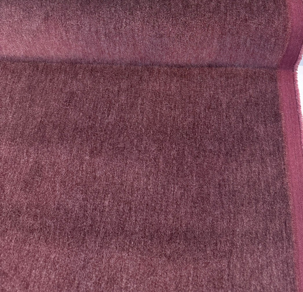 Fabricut mohair velvet in heathered Raspberry on the bolt with the selvage edge