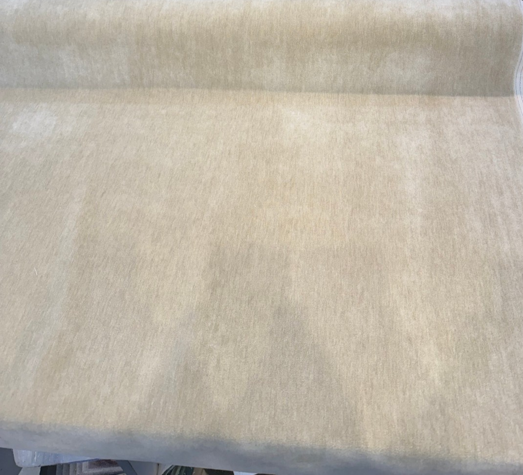 Fabricut mohair velvet in Blond Beige on the bolt showing the selvage edge