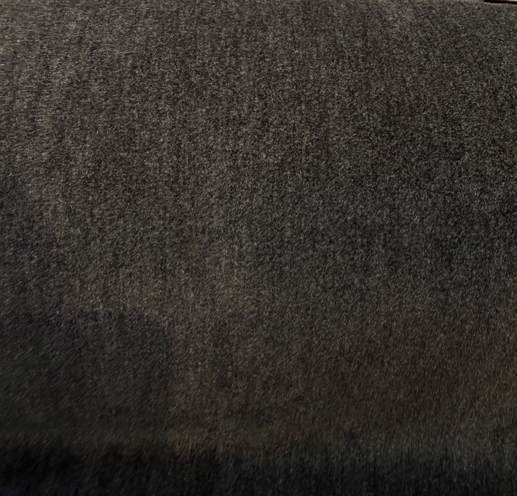 Fabricut mohair velvet in Obsidian Black draped in a swirl on the cutting table