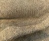 Honey bronze Dominator chenille bouclé upholstery fabric on the cutting table