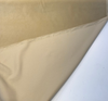 Warm tan Crypton velvet upholstery fabric laid flat on the cutting table