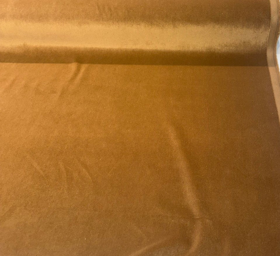 Crypton Sintra Rattan caramel performance velvet on the roll across the cutting table