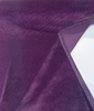 Deep aubergine Crypton velvet upholstery fabric with the selvage edge showing