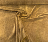 Fabricut mohair velvet Cognac gold upholstery fabric spread across the table