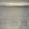 Cool slate gray Crypton velvet upholstery fabric laid flat on the roll