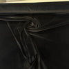 Deep black Crypton velvet upholstery fabric laid flat on the roll