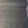 Selvage edge of charcoal gray Crypton performance velvet on the roll