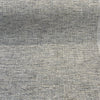 Gray tweed chenille Crypton Rushdie fabric laid flat on the roll