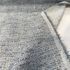 Crypton Rushdie Ocean Blue chenille folded back to show the cream backing and selvage