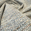 Crypton Rushdie Ocean Blue tweed chenille upholstery fabric draped in a swirl