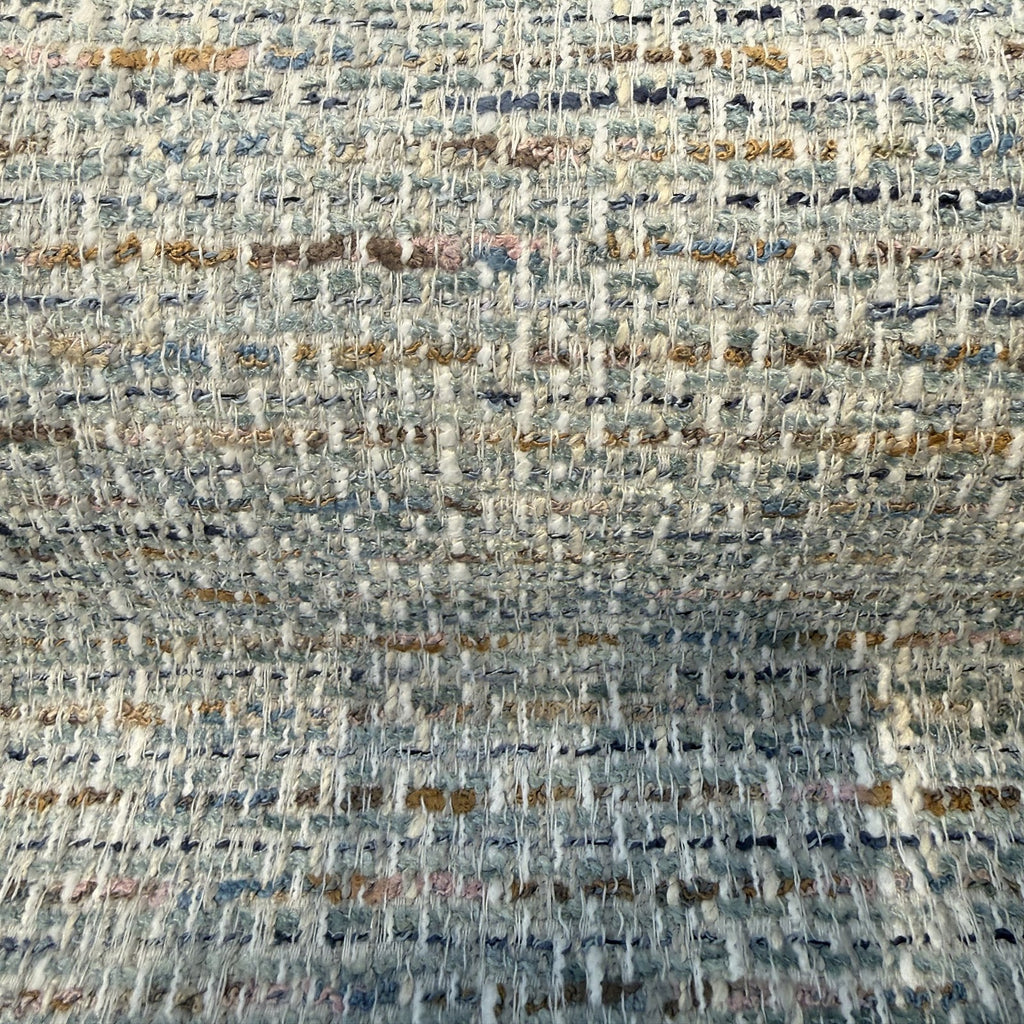 Close-up of the nubby sky blue, seafoam, navy and ochre tweed weave of Crypton Rushdie Ocean Blue