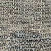 Close-up of the nubby charcoal, slate, brown and ivory tweed weave of Crypton Rushdie Charcoal
