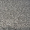 Charcoal gray tweed chenille Crypton Rushdie fabric laid flat on the roll