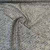 Crypton Rushdie Charcoal tweed chenille upholstery fabric draped in a swirl