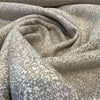Close-up of the nubby tan and ivory tweed weave of Crypton Naima Flax