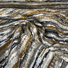 Swavelle Desert Stone Sienna taupe, gold and black stripe chenille draped in a swirl