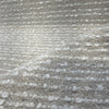 Fabricut Casio Porcelain boucle gathered to show the ivory loops