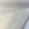 Fabricut Casio Porcelain boucle folded back to show the reverse side