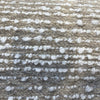 Close-up of Fabricut Casio Putty white boucle loops on taupe