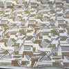 Spicer Fawn geometric chenille upholstery fabric laid flat on the roll