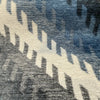 Close-up of Fabricut Monza Blue Jeans chenille velvet pile and ivory flame stitch