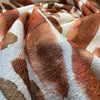 Close-up of Spencer Lava textured print in rust, caramel and burnt orange