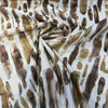 Spencer Gold Rush abstract print fabric swirled to show drape