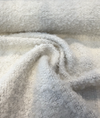 Gorky Snow white boucle fabric swirl showing its soft drape