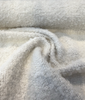 Gorky Snow white boucle fabric swirl showing its soft drape